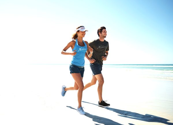 runners on the beach wearing steadfast shoes
